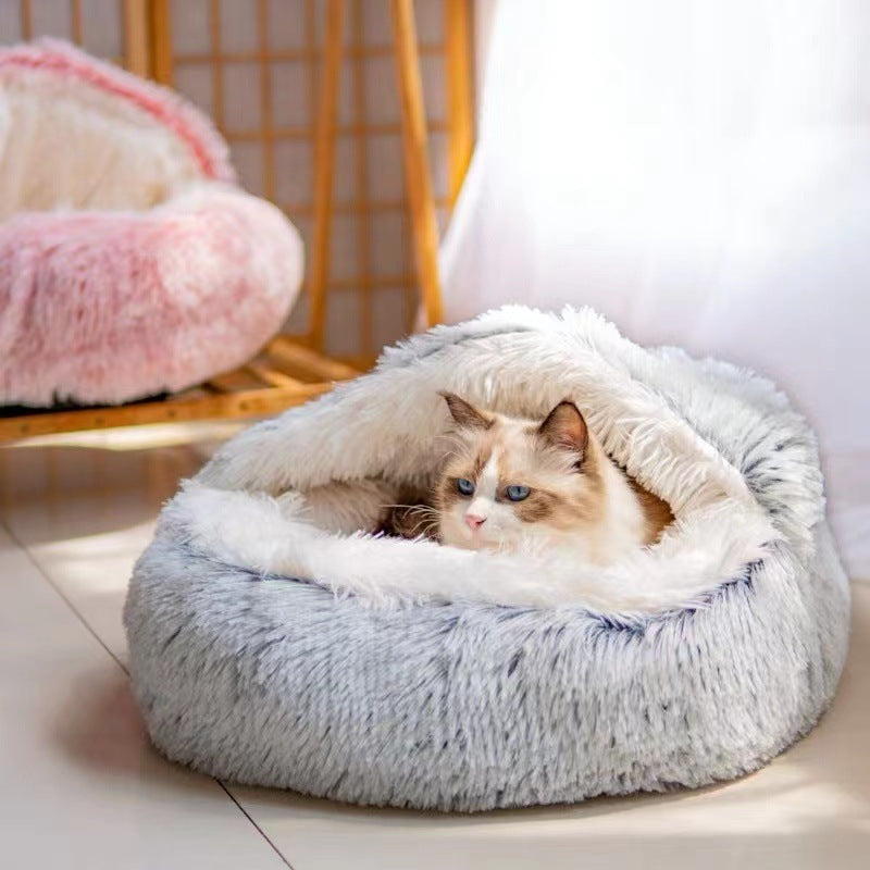 Cat lying in a fluffy pet bed cave style