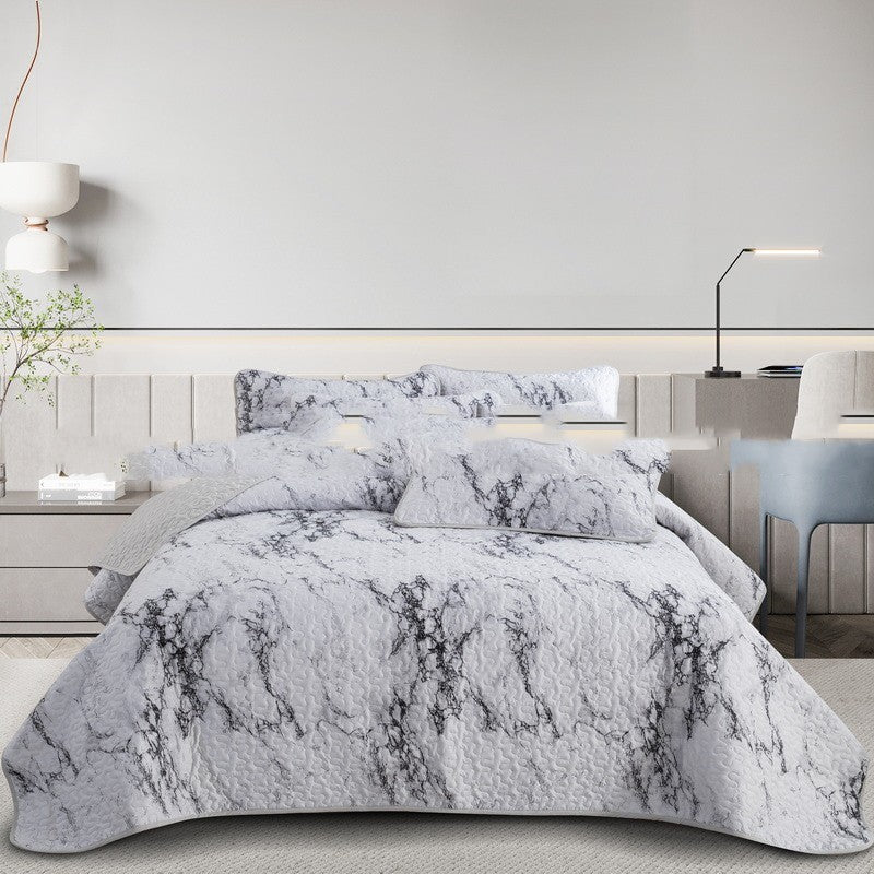 Gray marble patterned comforter set on a bed in a modern bedroom.