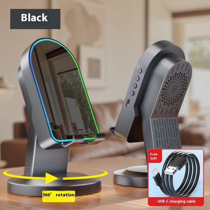 Black phone stand with 360-degree rotation feature and USB-C charging cable on a table.