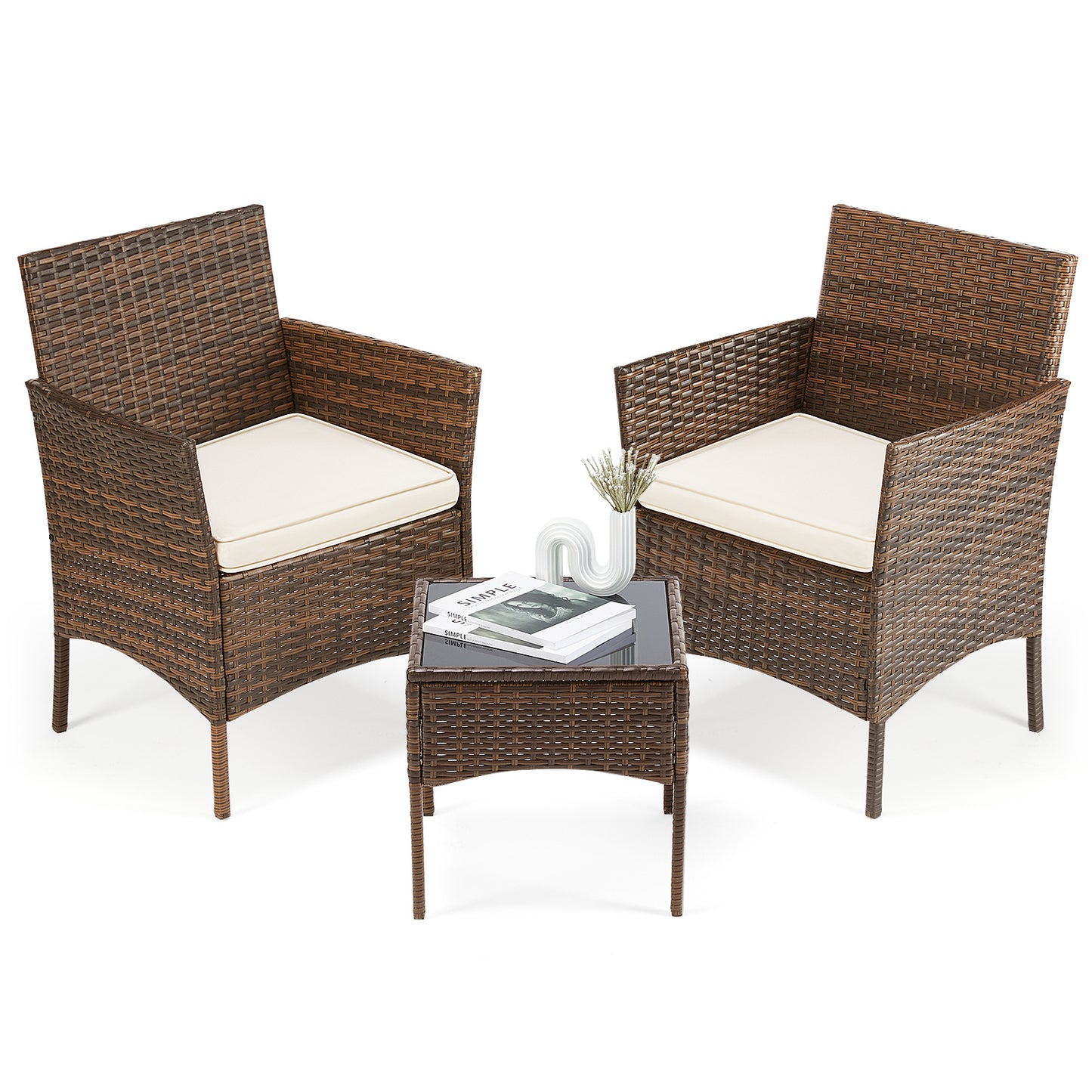 Two wicker chairs with white cushions and a matching table on a white background