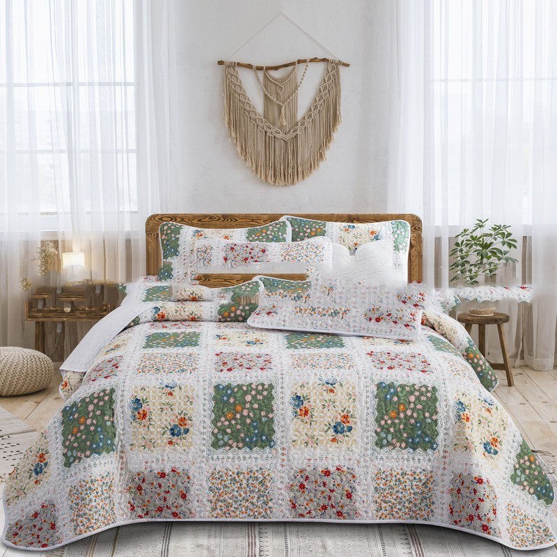 Decorative Floral quilt set on a bed 