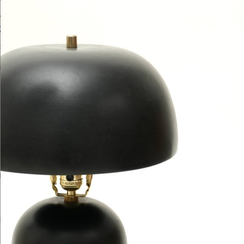 Black table lamp with gold accents on a white background